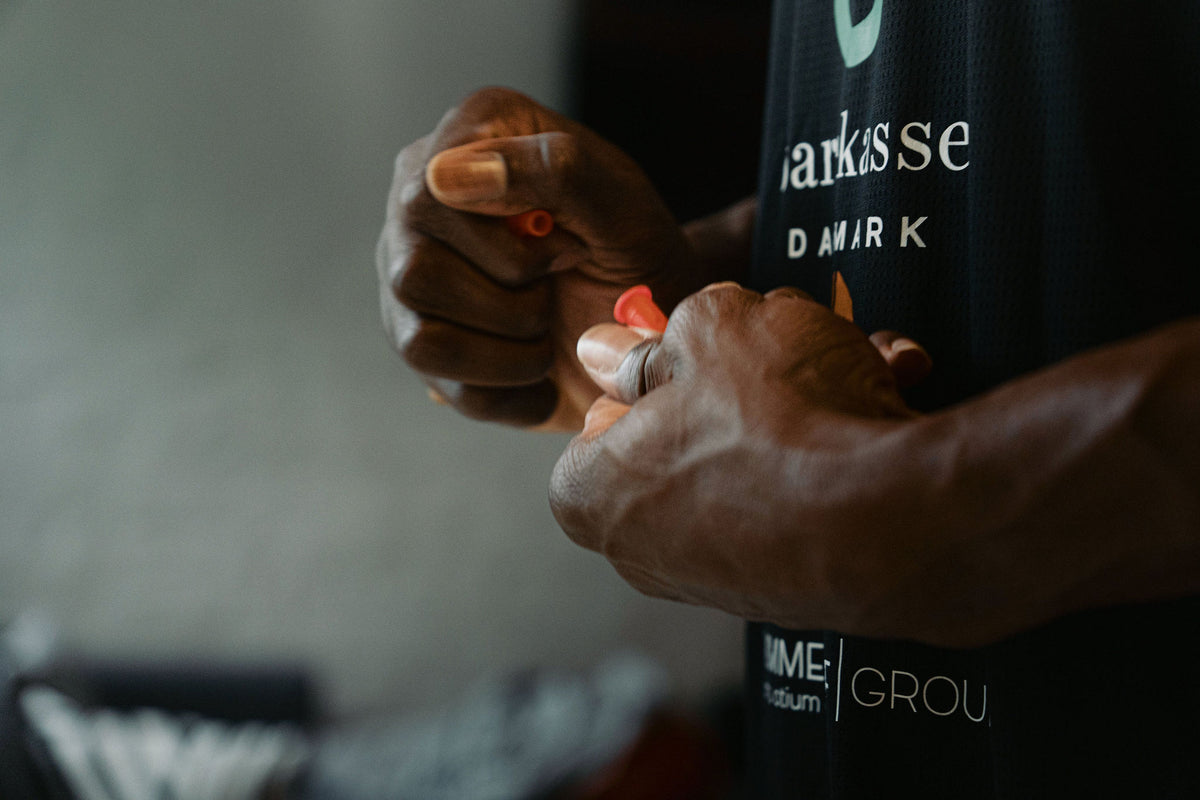 Hands holding the red Plug-In that carries the fragrance stick